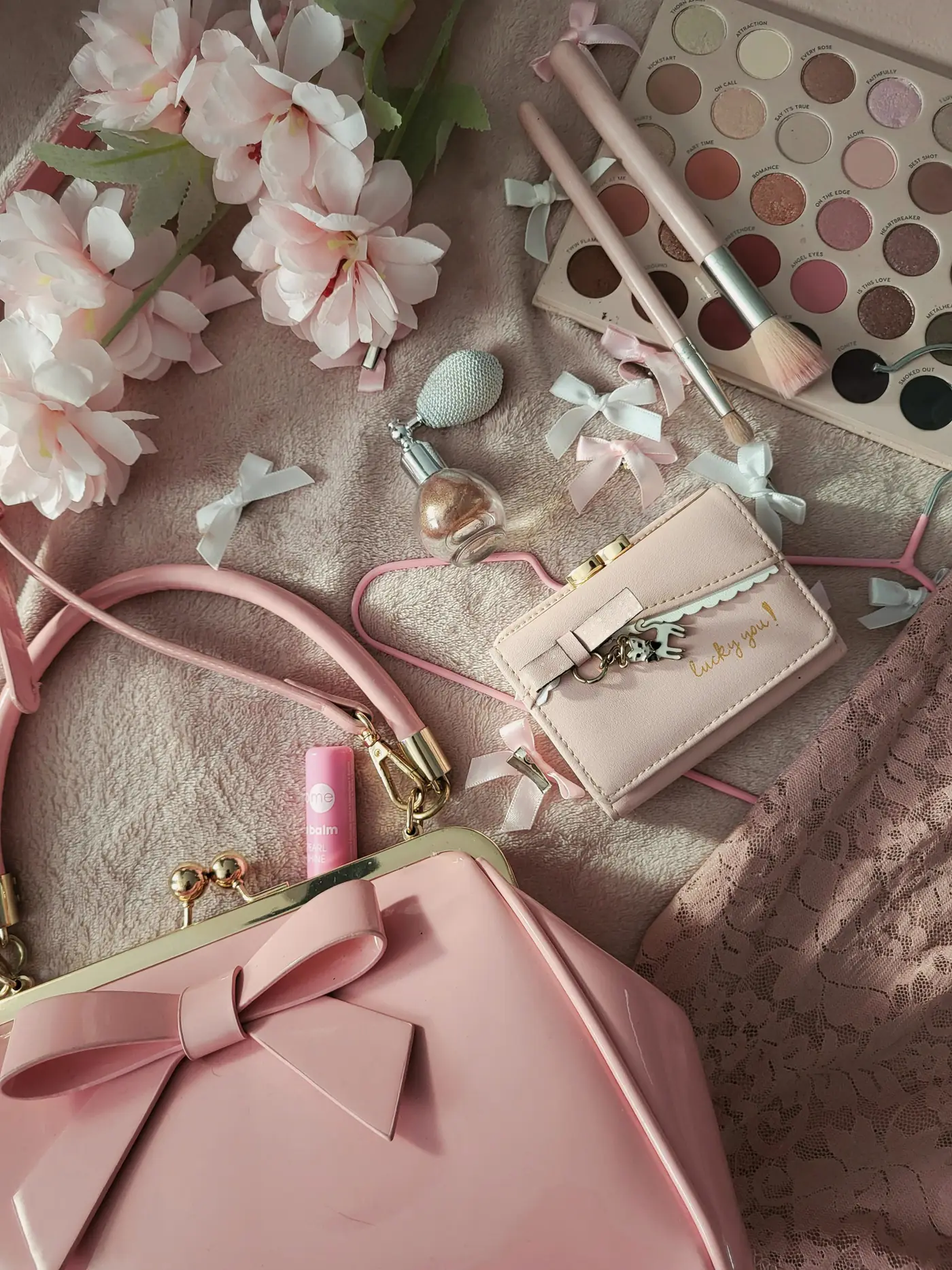 Editorial beauty and accessories flat lay in blush tones